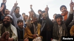 FILE - Afghan fans watch the 2015 Cricket World Cup match between Afghanistan and Bangladesh at a roadside stall in Kabul, Feb. 18, 2015.