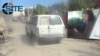 A frame from a propaganda video by the Islamic State group shows a white car alongside an inset image of a young man who appears to be Melbourne teen Jake Bilardi sitting in a driver's seat at an undisclosed location, allegedly before he attacked an Iraqi