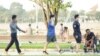 Cambodian residents wearing face masks walk on a street in Phnom Penh, Cambodia, on March 15, 2021. (Hean Socheata/VOA Khmer)