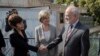 Iraqi Foreign Minister Ibrahim al-Jaafari, right, shakes hands with the Australian Ambassador to Iraq Lyndall Sachs, as Australian Foreign Minister Julie Bishop looks on in Baghdad, Iraq, Saturday, Oct. 18, 2014.
