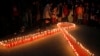 FILE - Nepalese women and children light candles on the eve of World AIDS Day in Kathmandu, Nepal, Nov. 30, 2015. 