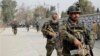 FILE - Afghan security forces patrol the site of a deadly suicide attack in Jalalabad, east of Kabul, Afghanistan, Jan. 24, 2018. The country plans to add 36,000 men to augment its existing forces with a contingent that would be charged with defending areas military-led operations have cleared of Taliban insurgents, but some see the initiative as controversial.