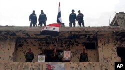 Les forces militaires et de police syriennes dans le quartier de Hajar al-Aswad, Damas, Syrie, 22 mai 2018. 
