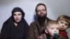A still image from a video posted by the Taliban on social media on Dec. 19, 2016, shows American Caitlan Coleman speaking next to her Canadian husband, Joshua Boyle, and their two sons. 