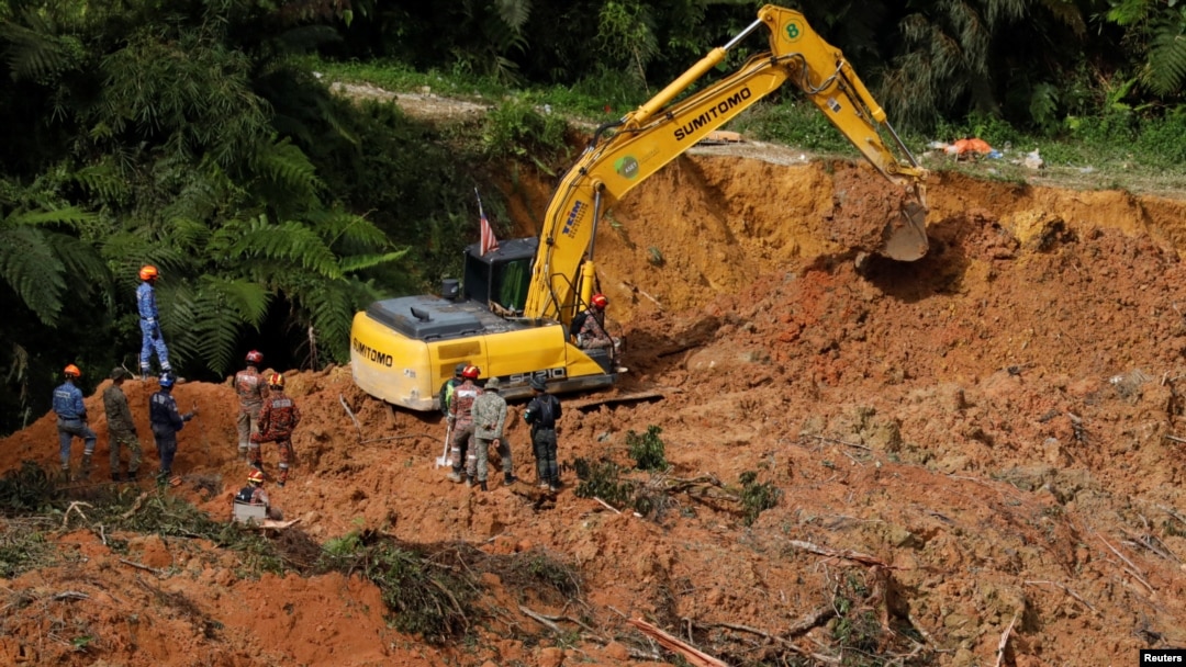 Rescuers work during a rescue and evacuation operation following a landslide at a campsite in Batang Kali