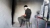 FILE - A blindfolded man waits to be interrogated in a prison in Aleppo, Syria, Oct. 6, 2014. Activists say more than 110,000 detainees are currently being held in Syria, most of them by the government of President Bashar al-Assad.