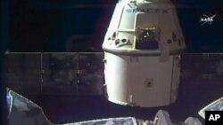 In this frame grab taken from NASA Television, a SpaceX Dragon capsule separates from a robotic arm of the International Space Station en route back to Earth with a load of science experiments and gear from the space station, Aug. 26, 2016. 