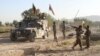 FILE - Afghan national army soldiers stand near the body of a Taliban fighter killed in Ghazni province, eastern Afghanistan, Sept. 14, 2015. The Afghan intelligence agency, the National Directorate of Security (NDS), says, Dec. 5, 2017, joint U.S.-Afghanistan operation have killed several high-profile leaders of al-Qaida, along with 80 other members of the terrorist network and Taliban fighters.