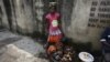 FILE - A 12-year-old girl sells fish on a street in the Obalende area of Lagos, Nigeria, June 17, 2014. Thousands of Nigeria's girls have to quit school to work as petty traders and support their families. 