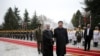 Chinese President Xi Jinping, center right, shakes hands with Iranian President Hassan Rouhani, as they pose for a photograph in an official arrival ceremony, at the Saadabad Palace in Tehran, Iran, Jan. 23, 2016. 