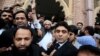 Hafiz Saeed (C) reacts to supporters as he walks out of court after a Pakistani court ordered his release from house arrest in Lahore, Pakistan, Nov. 22, 2017. 
