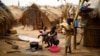 FILE - Families living in a refugee camp prepare food in Kaga-Bandoro, Central African Republic, Feb. 16, 2016. Nearly half of the country's population of 4.6 million is in need of humanitarian assistance.
