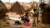 FILE - Families prepare food in a refugee camp in Kaga-Bandoro, Central African Republic, Feb. 16, 2016. Ex-Seleka fighters attacked a refugee camp there Oct. 12. 