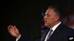 FILE - Australia's Treasurer Joe Hockey delivers a closing statement to the media during a press conference at the G-20 Finance Ministers and Central Bank Governors meeting in Sydney, Australia, Feb. 23, 2014.