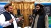 FILE - Tehreek-e-Taliban Pakistan (TTP) spokesman Ehsanullah Ehsan (L) talks with new TTP member Adnan Rasheed following a press conference in Shabtoi, a village in Pakistan's South Waziristan, on February 2, 2013. 