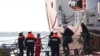 People disembark from the Ocean Viking rescue ship, at the Taranto harbor, Southern Italy, Jan. 29, 2020.