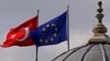 FILE - Flags of Turkey and the European Union are seen over the dome of a mosque in Istanbul, Turkey, Oct. 4, 2005. 