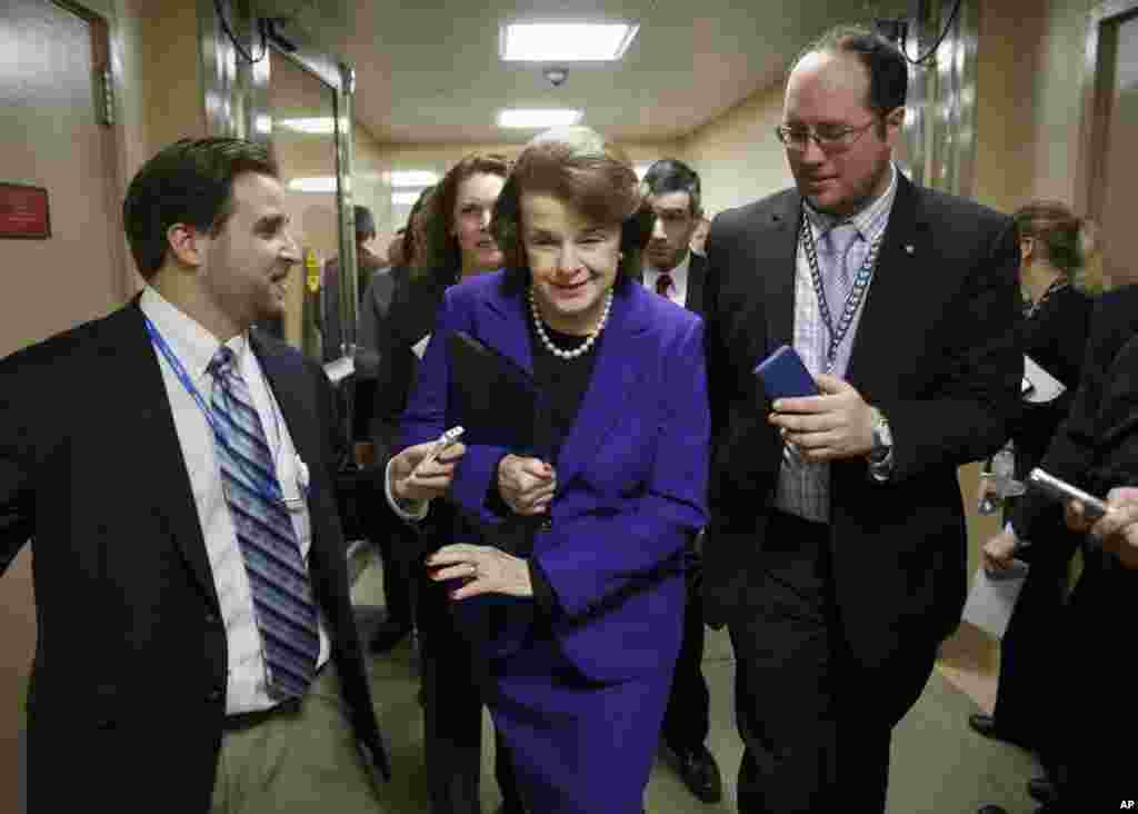 Senate Intelligence Committee Chair Sen. Dianne Feinstein, D-Calif. is pursued by reporters as she arrives to release a report on the CIA's harsh interrogation techniques at secret overseas facilities, Washington, Dec. 9, 2014.