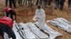A rescue worker labels bags containing dead bodies of migrants who were washed up on a beach near the city of Zawiya, Libya Feb. 20, 2017. 