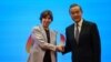 Chinese Foreign minister Wang Yi (R) and French Foreign minister Catherine Colonna shake hands during the 6th China-France high-level dialogue on people-to-people exchange at Peking University in Beijing on November 24, 2023.