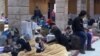 A still image taken from a video, said to have been shot Jan. 4, 2017, shows civilians, who were evacuated from Wadi Barada, sitting inside a shelter in the Damascus suburb of Rawda, Syria.