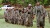 FILE - A group of armed fighters from the Kurdistan Workers Party, or PKK, enter northern Iraq on May 14, 2013. Turkey launched new artillery strikes against the PKK, officials said on July 27, 2024.