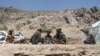 Taliban fighters eat lunch in Shindand district of Herat province, Afghanistan, May 27, 2016.