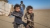 Internally displaced Syrian children who fled Raqqa city stand near their tent in Ras al-Ain province, Syria, Jan. 22, 2017. UNICEF is earmarking $1.4 billion to go toward helping 17 million children and families caught up in war inside Syria and living as refugees in five neighboring countries.