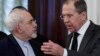 FILE - Russian Foreign Minister Sergei Lavrov, right, speaks to Iranian Foreign Minister Mohammad Javad Zarif as they enter a hall for the talks in Moscow, Russia, Dec. 20, 2016. In the past few years an alliance — at times shaky — between Moscow and Tehran has developed. 